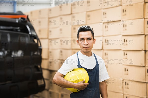 Worker standing in manufacturing plant