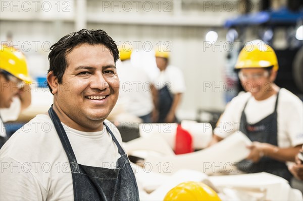 Worker smiling in manufacturing plant