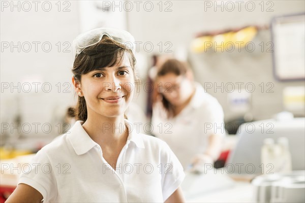 Worker smiling in manufacturing plant