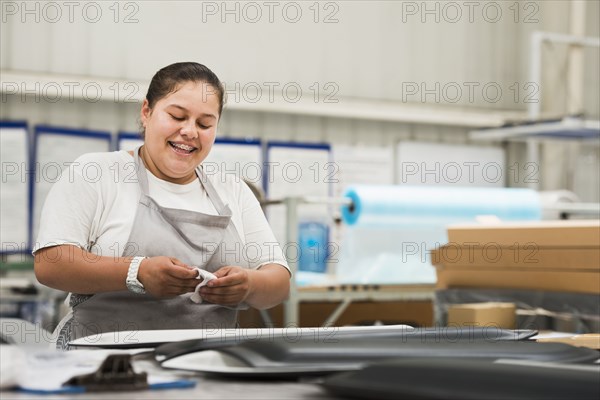 Worker smiling in manufacturing plant