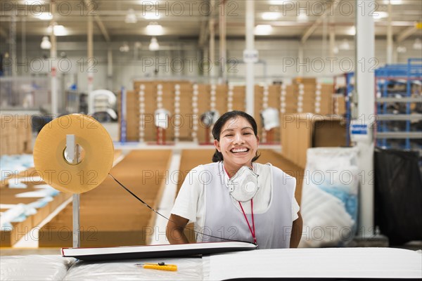 Worker smiling in manufacturing plant