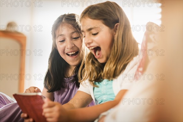 Girls using digital tablet together