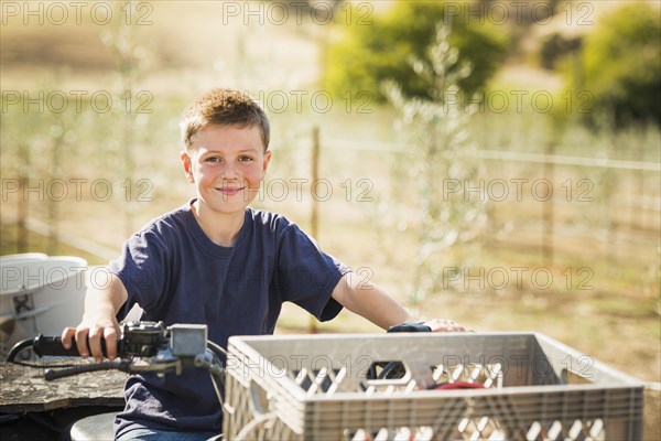 Caucasian boy driving four wheeler outdoors