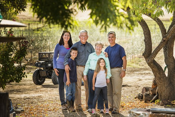 Family smiling in olive grove