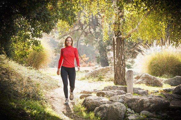 Caucasian woman walking on path