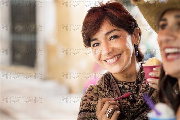 Hispanic woman eating ice cream