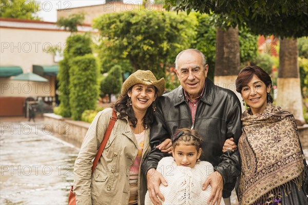 Family smiling together outdoors