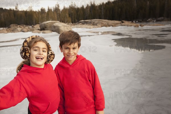 Children smiling together in forest