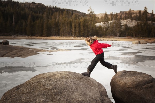 Girl playing on boulders