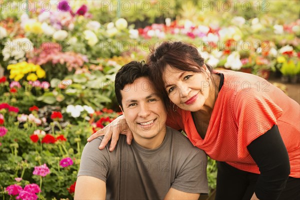 Hispanic couple smiling in field