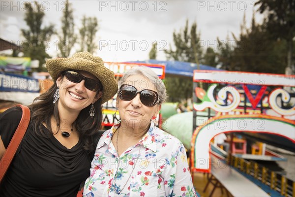 Hispanic women smiling at amusement park