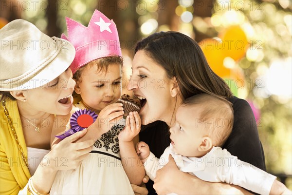 Hispanic family sharing cupcake