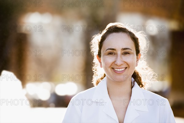 Hispanic doctor smiling outdoors
