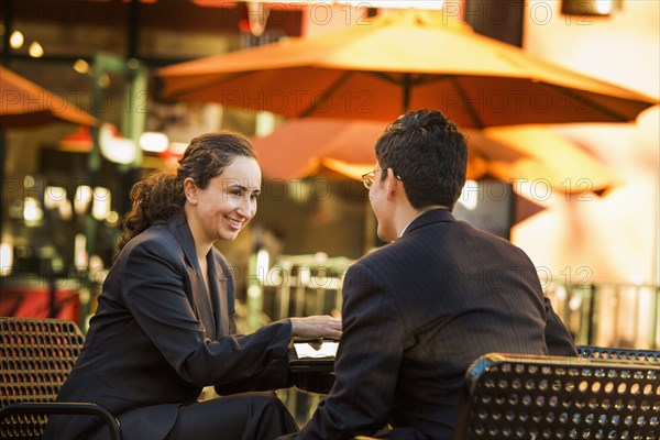 Hispanic business people working at cafe