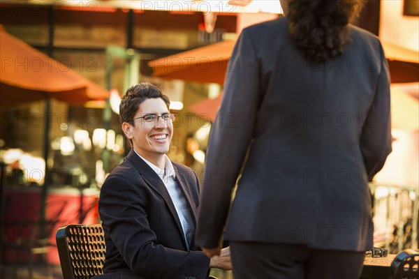 Hispanic business people working at cafe