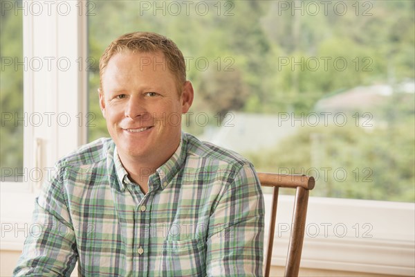 Caucasian man smiling indoors