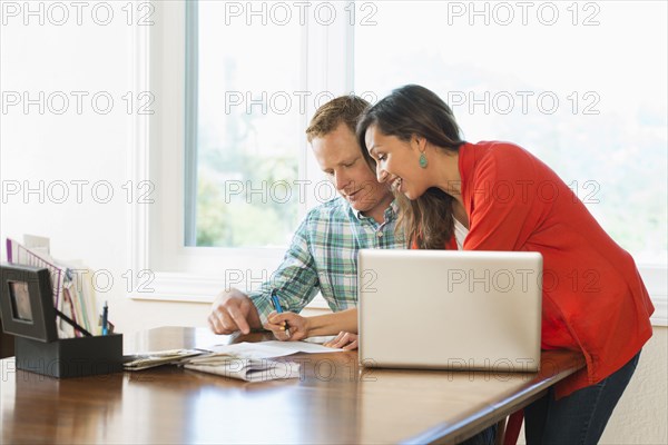Couple shopping online at table