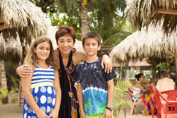 Woman and grandchildren smiling at resort