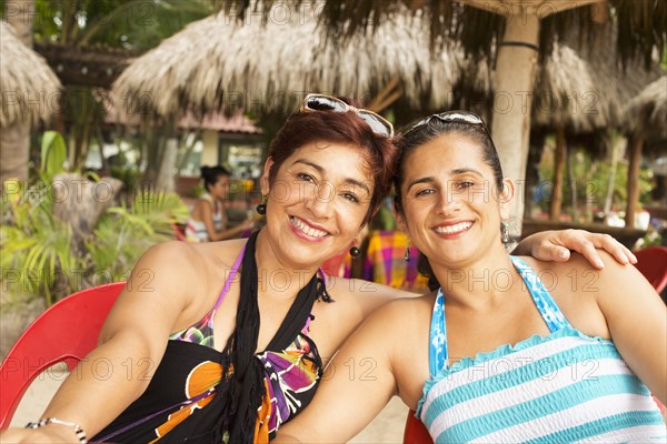 Hispanic women smiling at resort