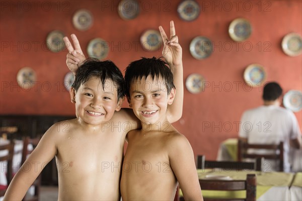 Boys giving each other bunny ears