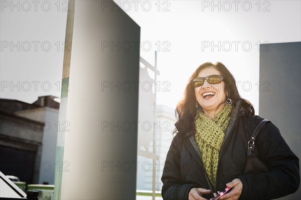 Hispanic woman walking on city street