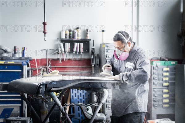 Hispanic mechanic working in auto shop