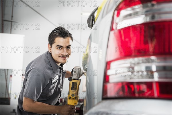 Hispanic mechanic working in auto shop