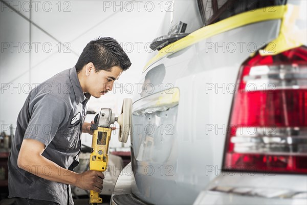 Hispanic mechanic working in auto shop