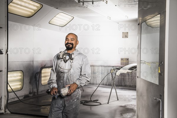 Hispanic mechanic working in auto shop