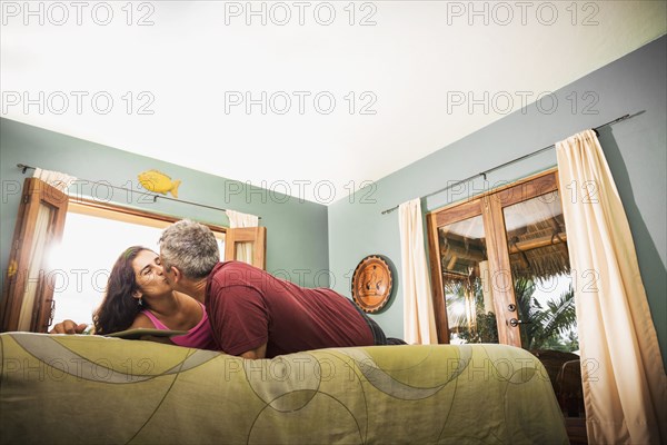 Couple kissing on bed