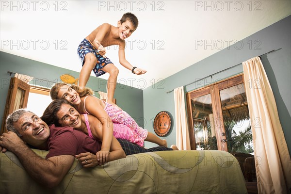 Family playing together on bed