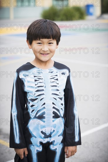 Portrait of Hispanic boy smiling in skeleton costume