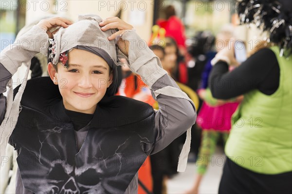 Portrait of smiling Caucasian boy in mummy costume