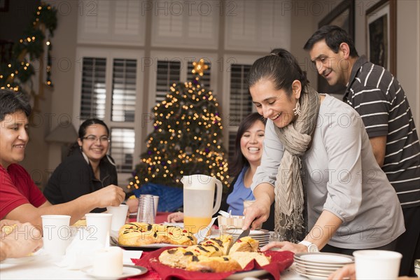 Hispanic family enjoying traditional Christmas dessert