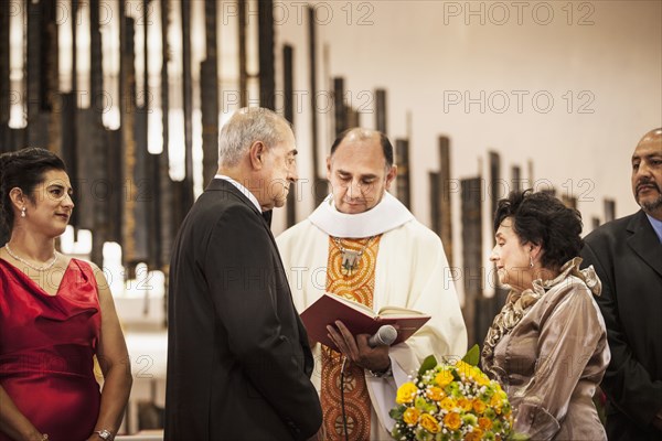 Senior couple exchanging vows at wedding