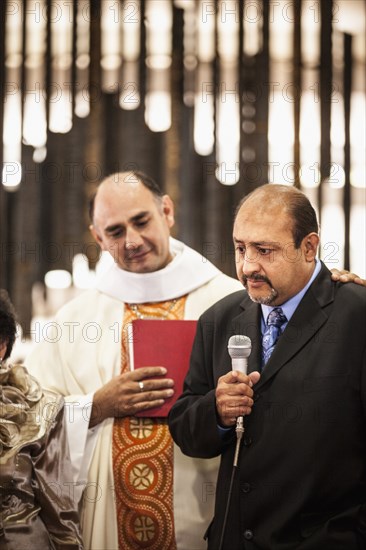 Man speaking at traditional wedding