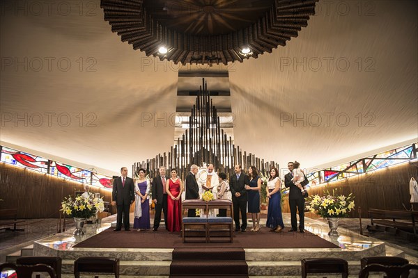 Family posing at wedding in church