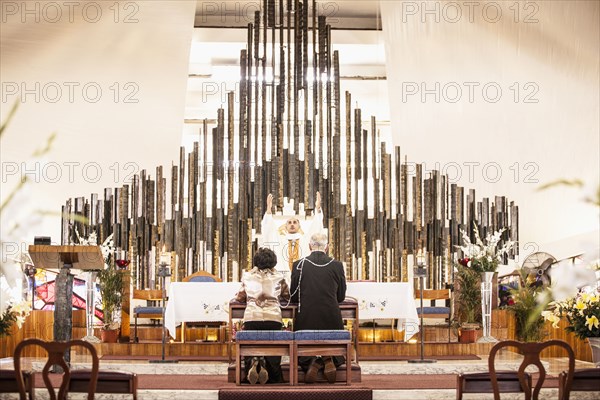 Couple praying at wedding in church