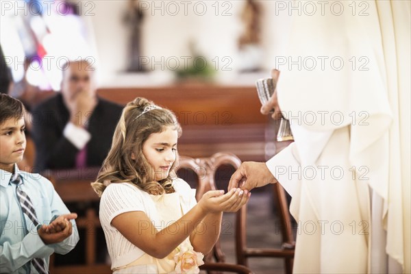 Girl taking her first communion at church