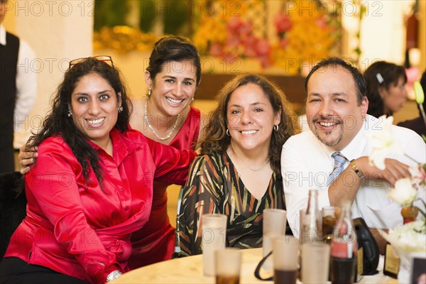 Hispanic family smiling at wedding reception