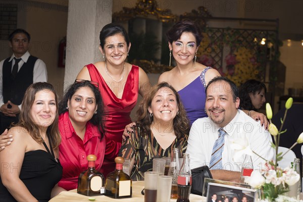 Hispanic family smiling at wedding reception