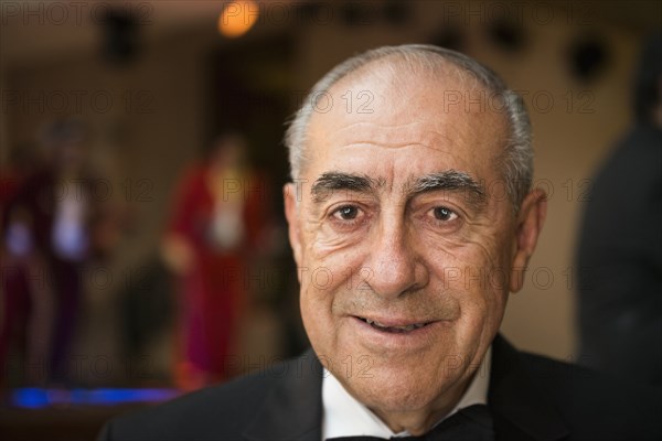 Hispanic man smiling at wedding reception