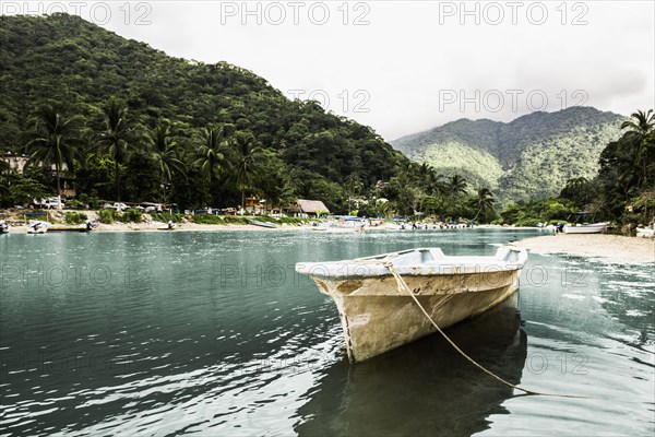 Docked boat floating in tropical bay