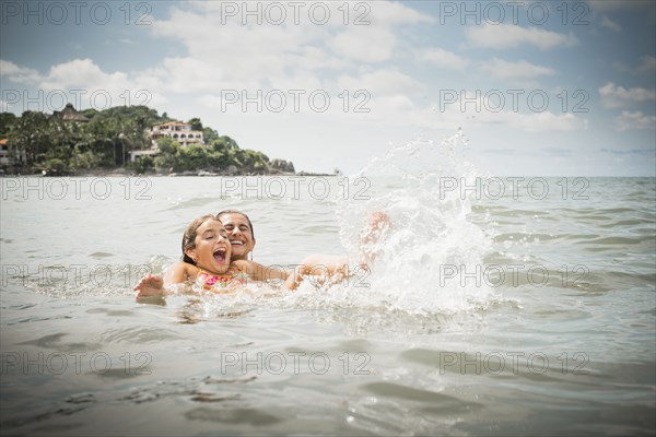 Father and daughter playing in lake