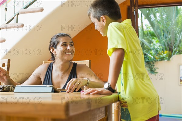 Mother and son talking at table