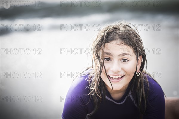 Mixed race girl with wet hair at beach