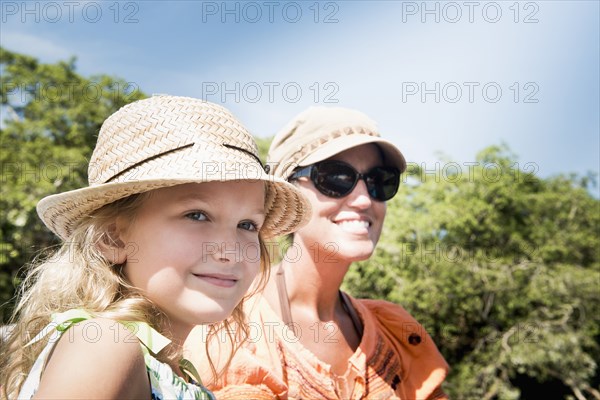 Caucasian mother and daughter smiling outdoors