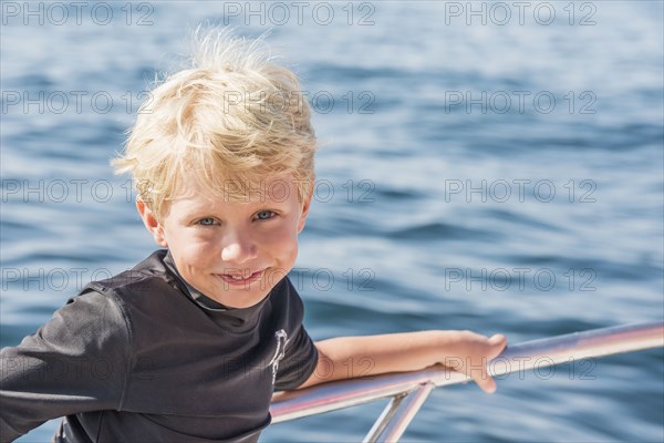 Caucasian boy smiling on boat