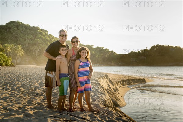 Family standing together on beach