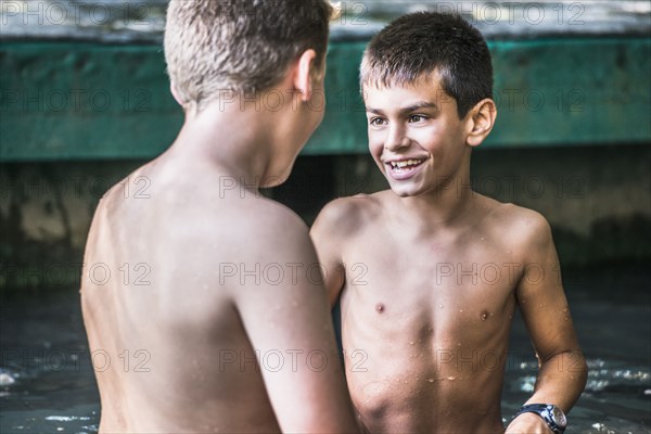 Boys talking outdoors